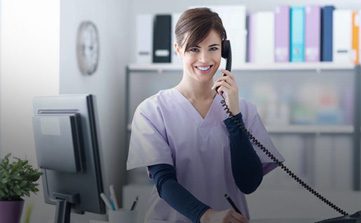 A brunette girl in a medical uniform - Medical Office specialist talking on the phone